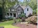 Charming two-story home with stone accents, a welcoming front porch, and beautiful landscaping at 1788 River Bluff Vw, Duluth, GA 30097