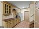 A kitchenette featuring brown cabinets, tile backsplash, sink, microwave and refrigerator at 1788 River Bluff Vw, Duluth, GA 30097