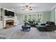 Comfortable living room with a stone fireplace, built-in shelving, and large windows that provide a scenic outdoor view at 1788 River Bluff Vw, Duluth, GA 30097