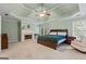 Spacious main bedroom featuring a fireplace, tray ceiling with fan, and large windows for natural light at 1788 River Bluff Vw, Duluth, GA 30097