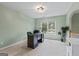 Study featuring a dark wood desk, neutral carpet, and bright light from the window at 1788 River Bluff Vw, Duluth, GA 30097