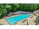 Community pool with ample seating, inviting residents to relax and enjoy the outdoors in a landscaped area at 1788 River Bluff Vw, Duluth, GA 30097