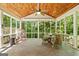 Relaxing screened-in porch with a wood ceiling, offering a peaceful view of the surrounding greenery at 1788 River Bluff Vw, Duluth, GA 30097