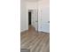 Bedroom with wood-look floors and white trim with access to an adjoining bathroom at 5502 Lakeview Pkwy, Villa Rica, GA 30180