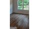 Bedroom with wood-look floors and large window at 5502 Lakeview Pkwy, Villa Rica, GA 30180
