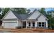 Charming, craftsman-style home featuring white siding, stone accents, and a welcoming front porch at 5502 Lakeview Pkwy, Villa Rica, GA 30180