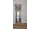 Hallway with wood-look floors and white walls leading to a room with a window at 5502 Lakeview Pkwy, Villa Rica, GA 30180