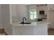 New kitchen features stainless appliances, quartz counters, and eat-in bar area at 5502 Lakeview Pkwy, Villa Rica, GA 30180