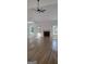 Bright living room with fireplace, ceiling fan, and wood-look flooring at 5502 Lakeview Pkwy, Villa Rica, GA 30180
