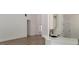 Open floor plan living room features white walls, wood-look flooring, and kitchen access at 5502 Lakeview Pkwy, Villa Rica, GA 30180