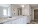 Bathroom featuring double sinks, granite countertops, white cabinets, shower, and tile floors at 1172 Faulkner Way, Jonesboro, GA 30238