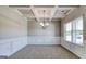 Formal dining room with decorative ceiling trim, carpet, and a large window for natural light at 1172 Faulkner Way, Jonesboro, GA 30238