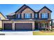 Two-story brick home featuring a three-car garage, black shutters and a manicured lawn at 1172 Faulkner Way, Jonesboro, GA 30238