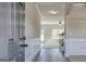 Hallway with hardwood floors, wood trim, and view into the living room with stairs and carpet at 1172 Faulkner Way, Jonesboro, GA 30238