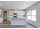 Bright kitchen features an island, white cabinets, subway tile backsplash, and stainless appliances at 1172 Faulkner Way, Jonesboro, GA 30238