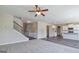Open living room with carpet, access to hardwood hallway, staircase, and open view to kitchen at 1172 Faulkner Way, Jonesboro, GA 30238