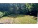 The backyard is spacious with mature trees that create a peaceful atmosphere at 120 E Cainwood E Ct, Atlanta, GA 30349