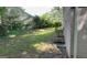 This home has a spacious, grassy backyard with a treeline in the distance at 120 E Cainwood E Ct, Atlanta, GA 30349