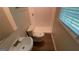This bathroom features a single sink, toilet, and a walk-in shower with wood look flooring at 120 E Cainwood E Ct, Atlanta, GA 30349