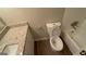 Bathroom featuring a granite countertop vanity, white cabinets, a toilet and a shower/tub combo at 120 E Cainwood E Ct, Atlanta, GA 30349