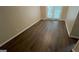 An airy living room is enhanced with stylish wood flooring and a door leading to the outdoors at 120 E Cainwood E Ct, Atlanta, GA 30349