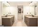 Bathroom featuring double vanities, framed mirrors and separate toilet area at 1884 Whitehawk Ct, Lawrenceville, GA 30043