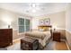 Bright bedroom with natural light, neutral walls and wood floors at 1884 Whitehawk Ct, Lawrenceville, GA 30043