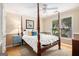 Bedroom with four poster bed, rug and windows letting in natural light at 1884 Whitehawk Ct, Lawrenceville, GA 30043