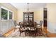 Well lit dining room with wood floor, white shutters, a chandelier, and a formal dining set at 1884 Whitehawk Ct, Lawrenceville, GA 30043
