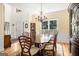 Elegant dining room features hardwood floors, wainscoting, and a chandelier above the wooden dining table at 1884 Whitehawk Ct, Lawrenceville, GA 30043