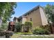 Tan home exterior featuring well manicured yard, back deck, and mature trees at 1884 Whitehawk Ct, Lawrenceville, GA 30043