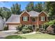 Charming brick home with lush landscaping and a well-manicured lawn creating great curb appeal at 1884 Whitehawk Ct, Lawrenceville, GA 30043