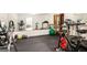 Bright basement gym with various exercise equipment and large mirror at 1884 Whitehawk Ct, Lawrenceville, GA 30043