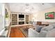 Cozy living room with hardwood floors, fireplace, TV and built-in bookshelves at 1884 Whitehawk Ct, Lawrenceville, GA 30043