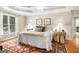 Spacious main bedroom with tray ceiling, hardwood floors, neutral walls, and generous natural light at 1884 Whitehawk Ct, Lawrenceville, GA 30043