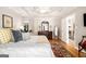 Tranquil main bedroom with tray ceiling, hardwood floors, and a charming view of the upstairs landing at 1884 Whitehawk Ct, Lawrenceville, GA 30043