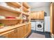 Spacious pantry with custom cabinets, ample shelving, and a modern washer, dryer, and refrigerator at 1884 Whitehawk Ct, Lawrenceville, GA 30043