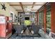 Cozy screened porch with brick flooring, ceiling fan, comfortable furniture, and vintage Coca-Cola cooler at 1884 Whitehawk Ct, Lawrenceville, GA 30043