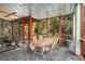 Screened sunroom with multiple seating areas, slate tile and views of nature at 1884 Whitehawk Ct, Lawrenceville, GA 30043