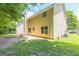 Spacious backyard with a yellow house and lush green trees, offering a serene outdoor space at 260 Redding Rdg, Atlanta, GA 30349
