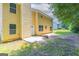 Yellow house with a backyard featuring a patio area and lush greenery for outdoor enjoyment at 260 Redding Rdg, Atlanta, GA 30349