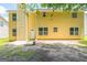 View of the back of the yellow house showing the outdoor patio area and green yard at 260 Redding Rdg, Atlanta, GA 30349