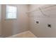 Bright laundry room with window, shelving, and utility connections at 260 Redding Rdg, Atlanta, GA 30349