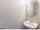 Small powder room featuring a pedestal sink and a neutral-colored wall at 260 Redding Rdg, Atlanta, GA 30349