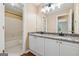 Bathroom features a granite countertop, double sinks, white cabinets, and a shower/tub combo at 3355 Golfe Links Dr, Snellville, GA 30039