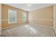 Well-lit bedroom featuring neutral walls, carpet, base molding, and two windows bringing in natural light at 3355 Golfe Links Dr, Snellville, GA 30039