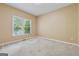 Cozy bedroom featuring natural light, neutral tones, and comfortable carpet at 3355 Golfe Links Dr, Snellville, GA 30039
