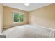 Bright bedroom featuring neutral walls, plush carpeting, and a large window offering ample natural light at 3355 Golfe Links Dr, Snellville, GA 30039