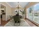 Elegant dining room with stylish chandelier, neutral walls, and sleek wood flooring at 3355 Golfe Links Dr, Snellville, GA 30039