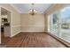 Elegant dining room with stylish chandelier, neutral walls, and sleek wood flooring at 3355 Golfe Links Dr, Snellville, GA 30039